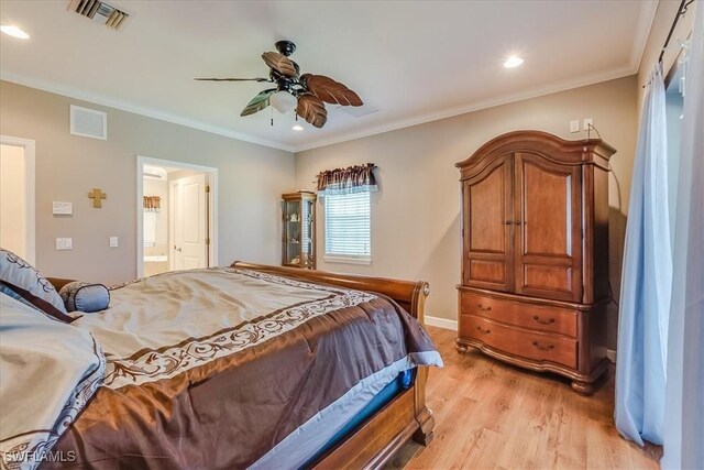 bedroom featuring ceiling fan, ensuite bathroom, light hardwood / wood-style floors, and ornamental molding