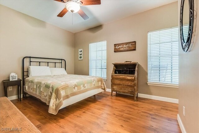 bedroom with hardwood / wood-style floors and ceiling fan