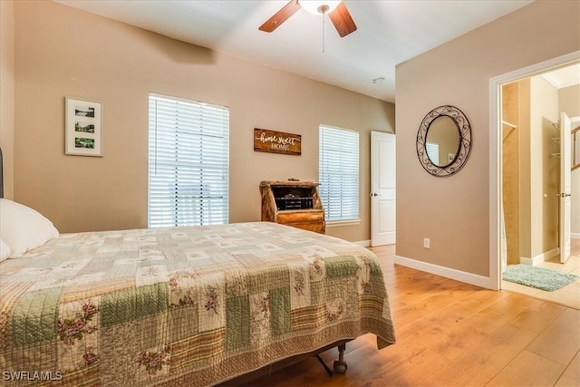 bedroom with ceiling fan, baseboards, and wood finished floors