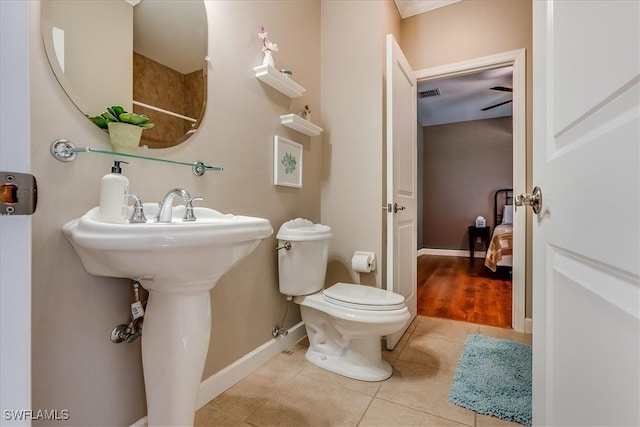 bathroom with toilet and wood-type flooring