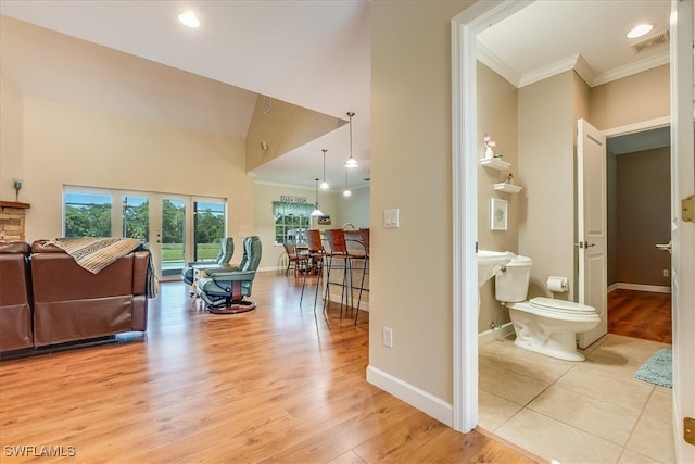 interior space featuring high vaulted ceiling and light hardwood / wood-style floors