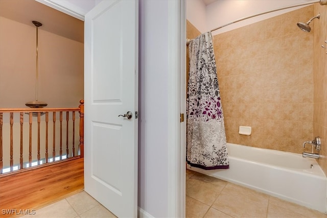 bathroom with hardwood / wood-style floors and shower / bath combo