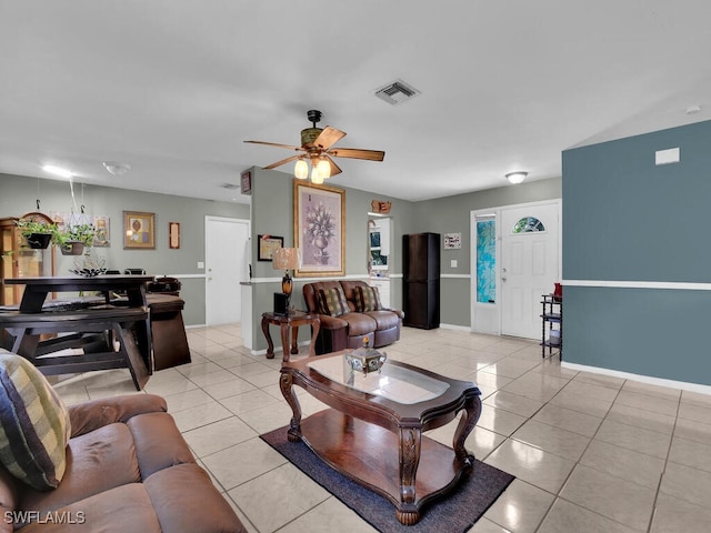 living room featuring ceiling fan and light tile patterned floors