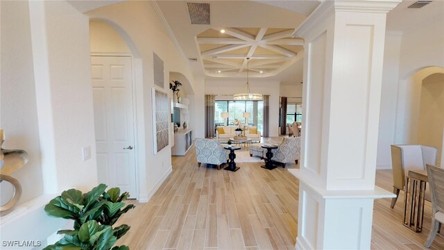 corridor featuring beam ceiling, light hardwood / wood-style flooring, coffered ceiling, and crown molding