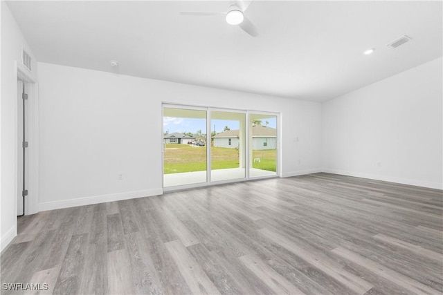 unfurnished room with baseboards, visible vents, and light wood-style floors