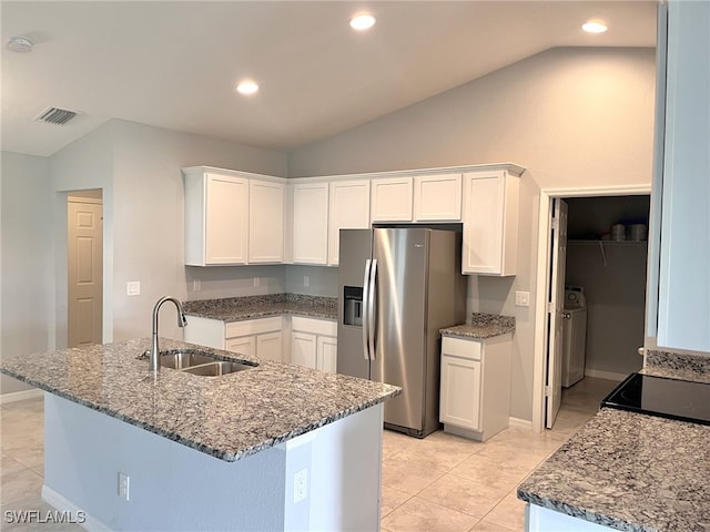 kitchen with sink, vaulted ceiling, light tile patterned floors, and stainless steel refrigerator with ice dispenser