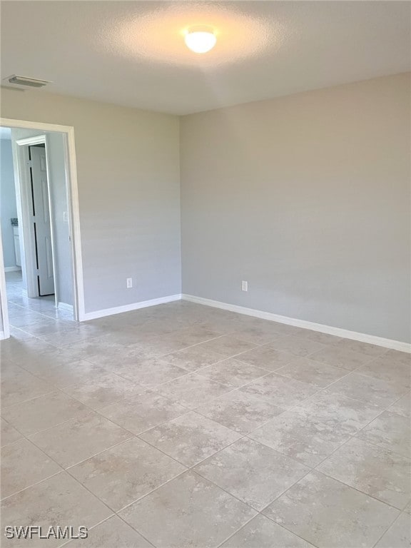 empty room with light tile patterned floors