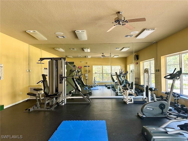 workout area with a textured ceiling, a healthy amount of sunlight, and ceiling fan