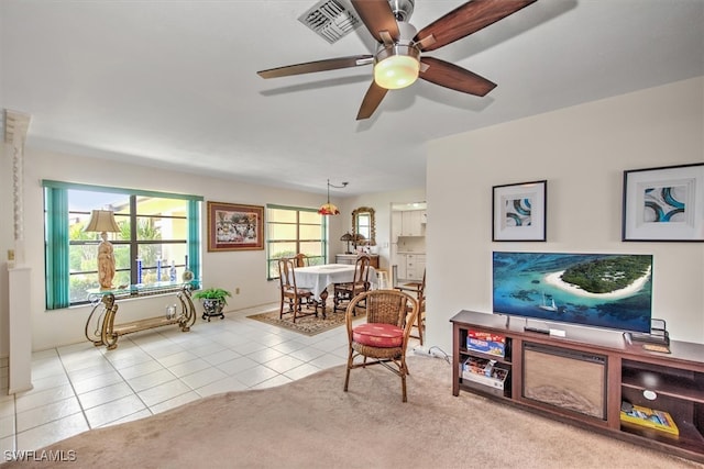 sitting room featuring light tile patterned floors and ceiling fan