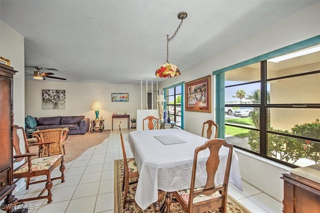 dining room featuring ceiling fan, light tile patterned flooring, and a textured ceiling