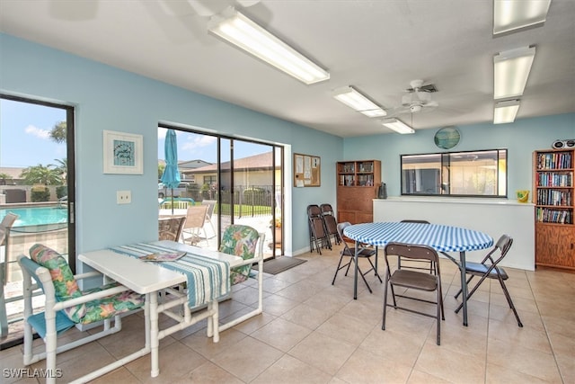 dining room with ceiling fan, light tile patterned floors, and plenty of natural light