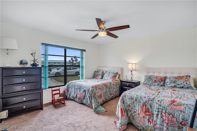 bedroom with ceiling fan and light carpet