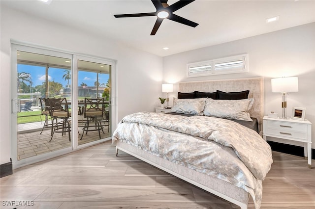 bedroom with ceiling fan, wood finished floors, and access to exterior