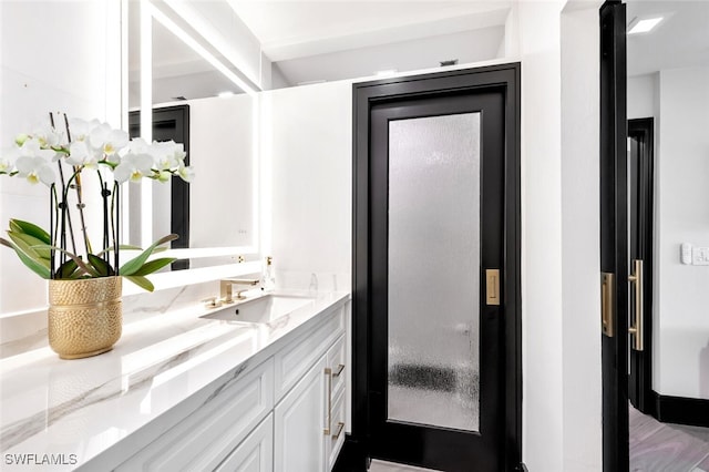 bathroom with vanity and hardwood / wood-style floors