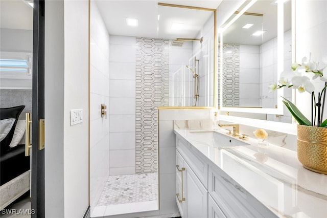 bathroom with vanity and tiled shower