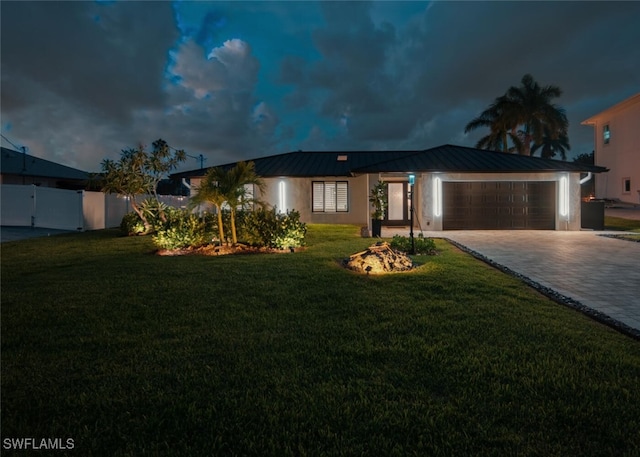 view of front of house featuring a yard and a garage