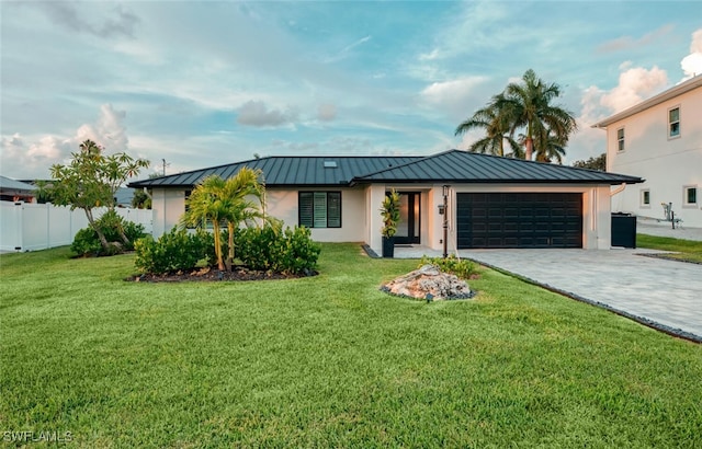 view of front of house featuring a front yard and a garage