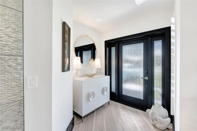 entryway with plenty of natural light and wood finished floors