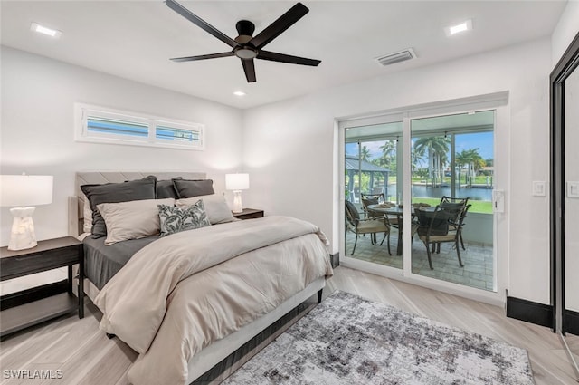 bedroom featuring wood finished floors, a ceiling fan, baseboards, visible vents, and access to exterior