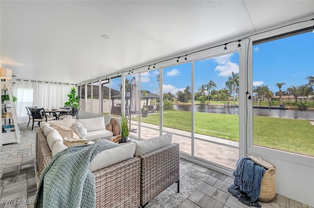 sunroom / solarium with a water view