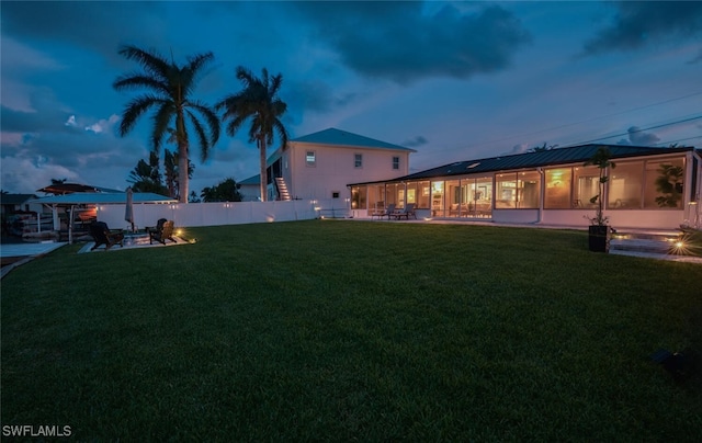 yard at dusk featuring a patio