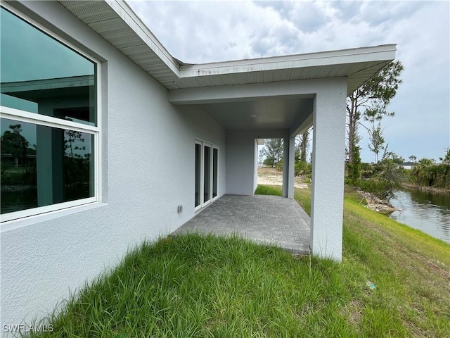 view of patio featuring a water view