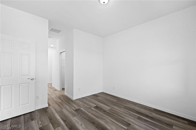 unfurnished room with dark hardwood / wood-style floors