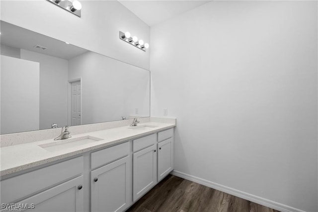 bathroom with hardwood / wood-style floors and vanity