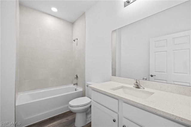 full bathroom featuring hardwood / wood-style floors, vanity, toilet, and shower / bathtub combination