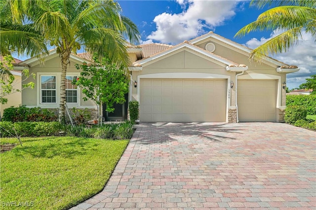 view of front of house with a front yard and a garage