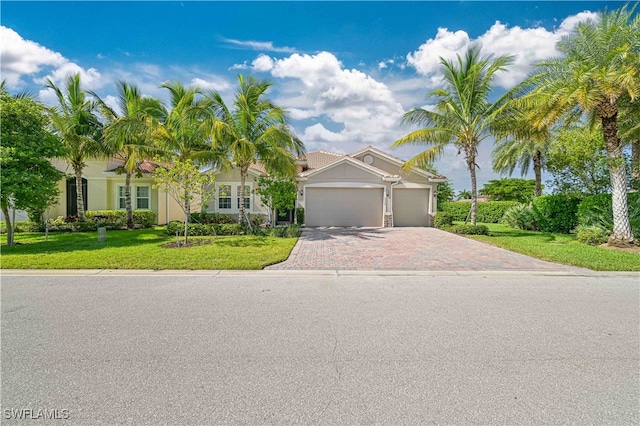 view of front of property featuring a front lawn and a garage