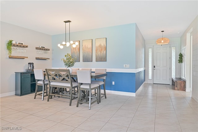 tiled dining area with a chandelier