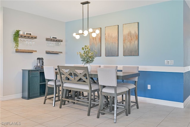 dining space featuring an inviting chandelier and light tile patterned floors