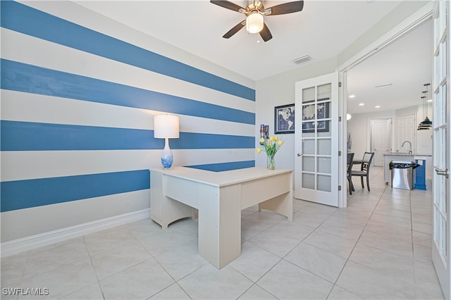 home office with light tile patterned floors, sink, and ceiling fan