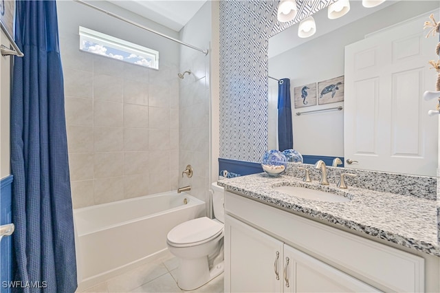 full bathroom featuring toilet, vanity, shower / bath combo with shower curtain, and tile patterned floors