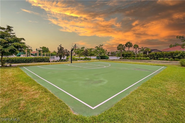 view of basketball court with a lawn and a playground