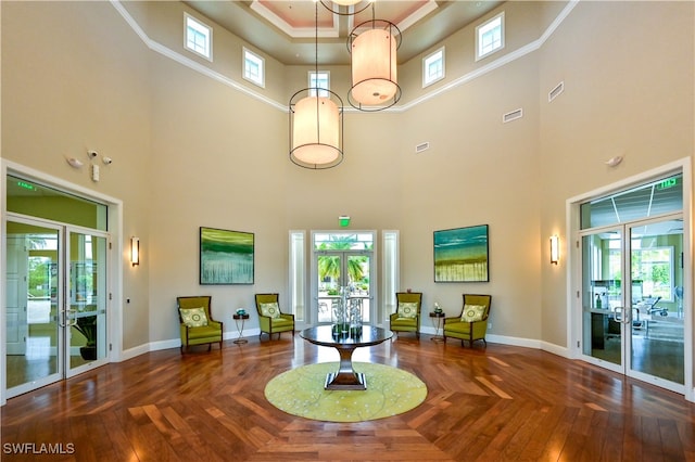 interior space featuring a high ceiling, a tray ceiling, and dark parquet flooring