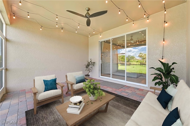 sunroom / solarium featuring ceiling fan