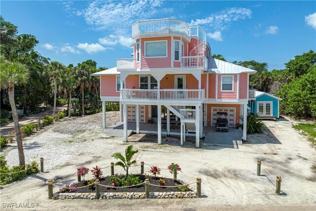 4501 Seair Ln, Upper Captiva, FL 33924 - back of property with stairway, french doors, a balcony, and metal roof