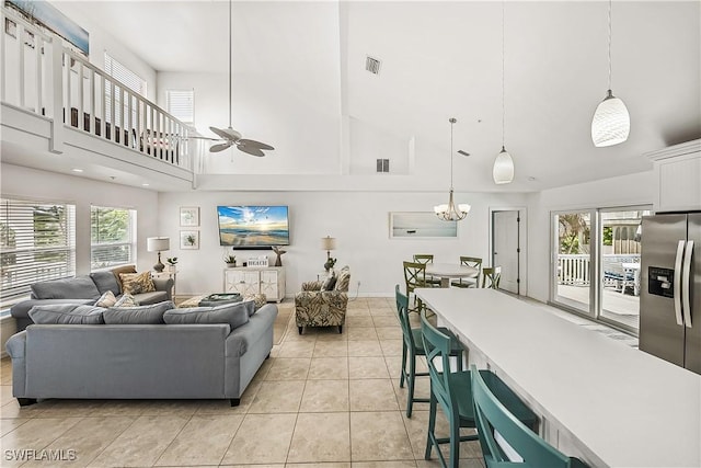 4501 Seair Ln, Upper Captiva, FL 33924 - living room with a towering ceiling, a ceiling fan, healthy amount of natural light, a chandelier, and light tile patterned flooring