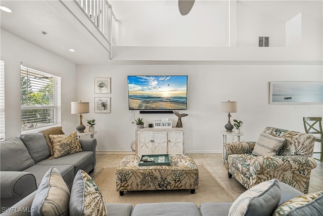 tiled living room with a towering ceiling