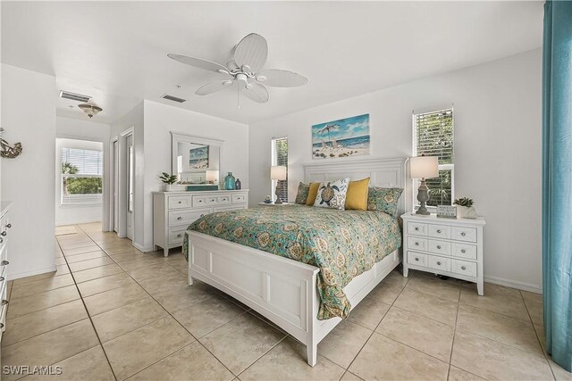 4501 Seair Ln, Upper Captiva, FL 33924 - bedroom with multiple windows, light tile patterned flooring, and a ceiling fan