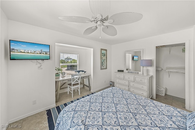 tiled bedroom with ceiling fan and a closet