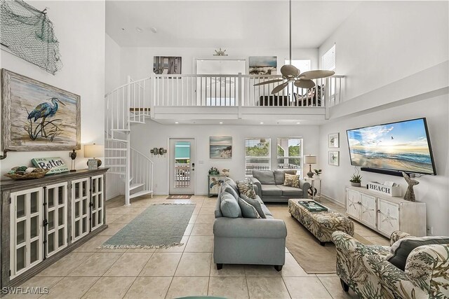 4501 Seair Ln, Upper Captiva, FL 33924 - living room featuring stairway, a high ceiling, tile patterned floors, and ceiling fan
