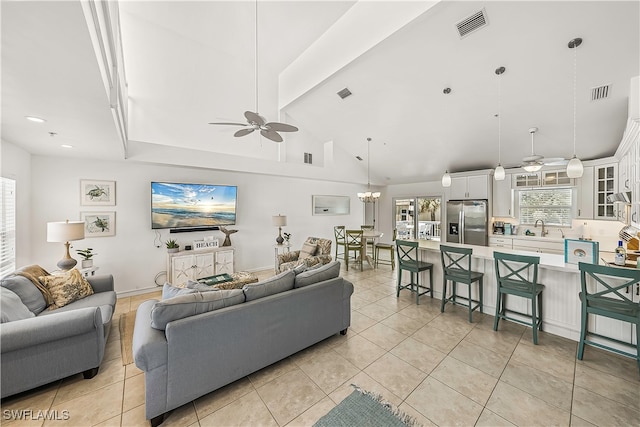 tiled living room featuring high vaulted ceiling, ceiling fan, beam ceiling, and sink