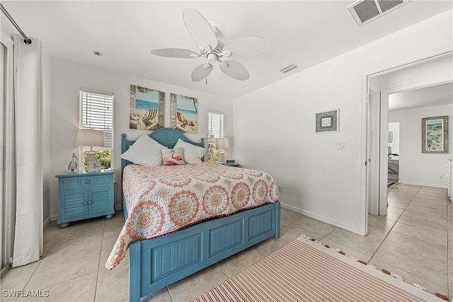 bedroom with ceiling fan and light tile patterned flooring