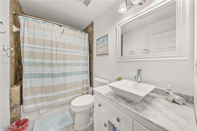 bathroom with vanity, toilet, and tile patterned flooring