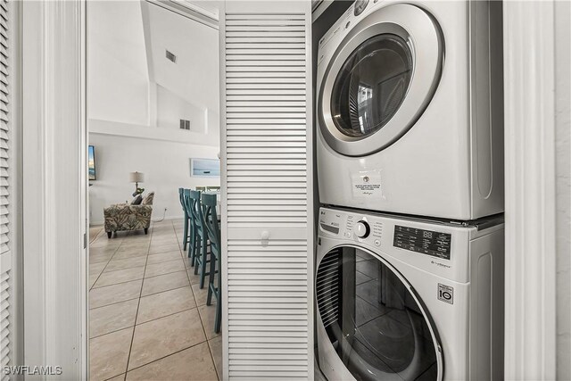 4501 Seair Ln, Upper Captiva, FL 33924 - washroom with stacked washer / drying machine and light tile patterned flooring