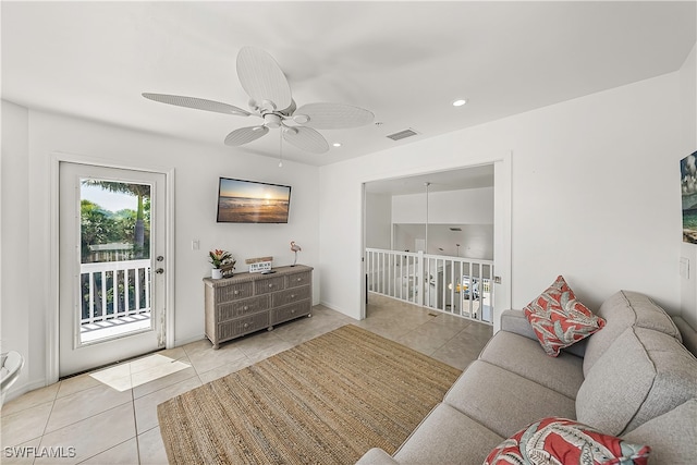 living room featuring ceiling fan and light tile patterned floors