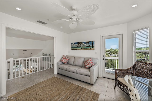 living room with plenty of natural light, ceiling fan, and light tile patterned flooring